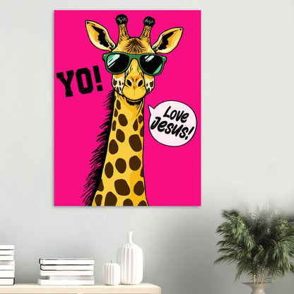 A colorful poster featuring a giraffe with sunglasses and a speech bubble that reads 'LOVE JESUS', set against a bold pink background displayed on a minimalist white wall above a console with books, ceramic vases, and a green plant