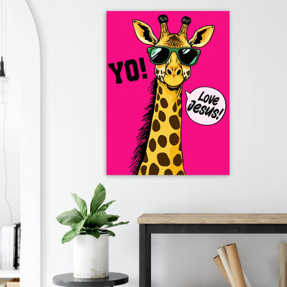 A colorful poster featuring a giraffe with sunglasses and a speech bubble that reads 'LOVE JESUS', set against a bold pink background displayed above a plant on a side table in a bright modern living room