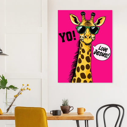 A colorful poster featuring a giraffe with sunglasses and a speech bubble that reads 'LOVE JESUS', set against a bold pink background hanging above a wooden table in a modern dining space