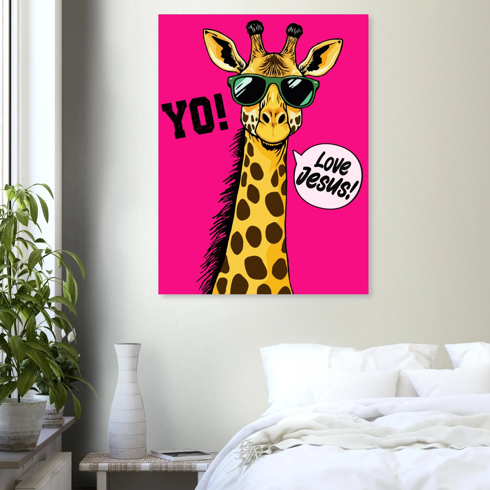 A colorful poster featuring a giraffe with sunglasses and a speech bubble that reads 'LOVE JESUS', set against a bold pink background styled in a modern bedroom interior