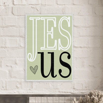 Decorative sign with 'JESUS' text on a light green background, mounted on a brick wall.