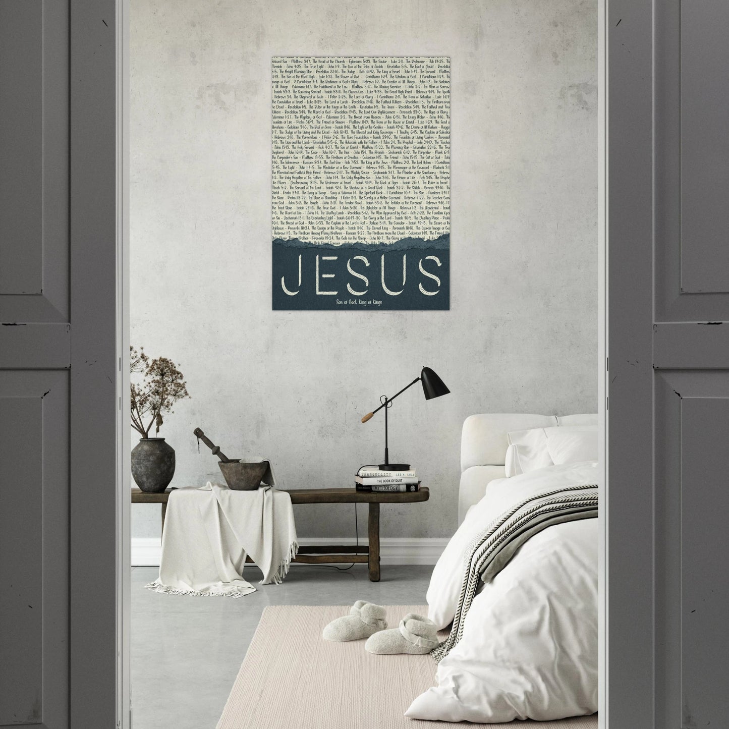 jesus names typography canvas hanging above a bed in a peaceful neutral bedroom