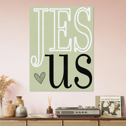 Decorative wall art with 'Jesus' on a light green background, placed above a wooden shelf with decorative items.