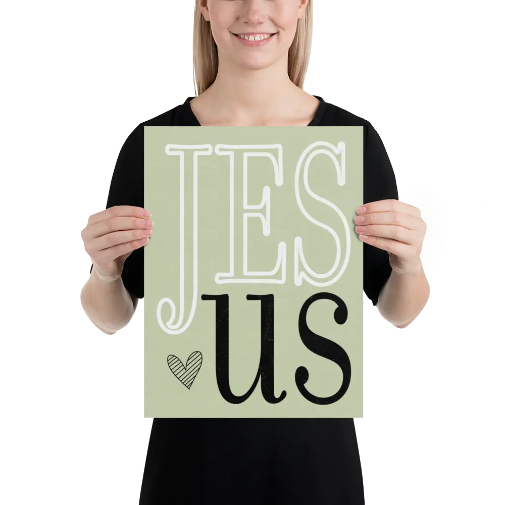 Person holding a sign with 'Jesus' on a light green background