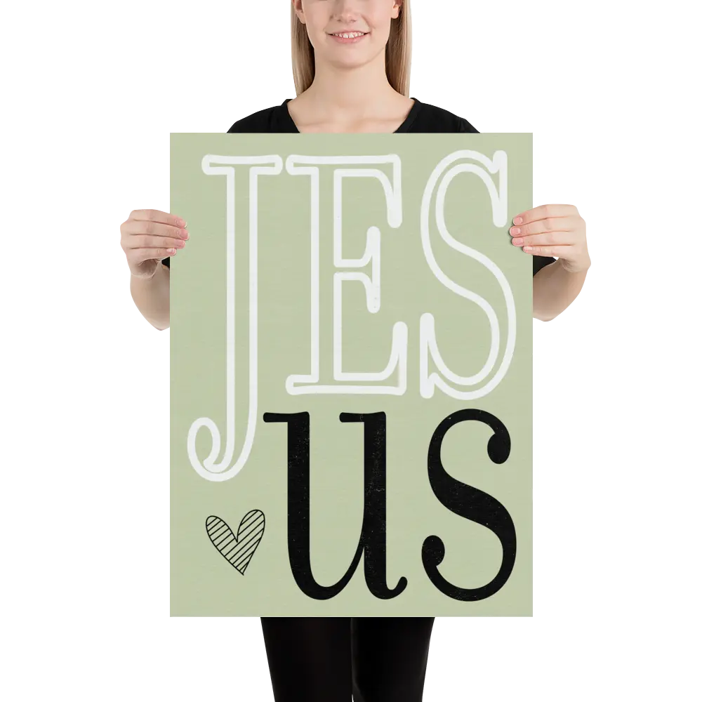 Person holding a sign with 'Jesus' on a light green background