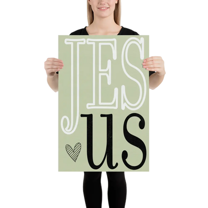 Person holding a sign with 'JESUS' on a light green background