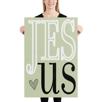Person holding a sign with 'JESUS' text on a light green background