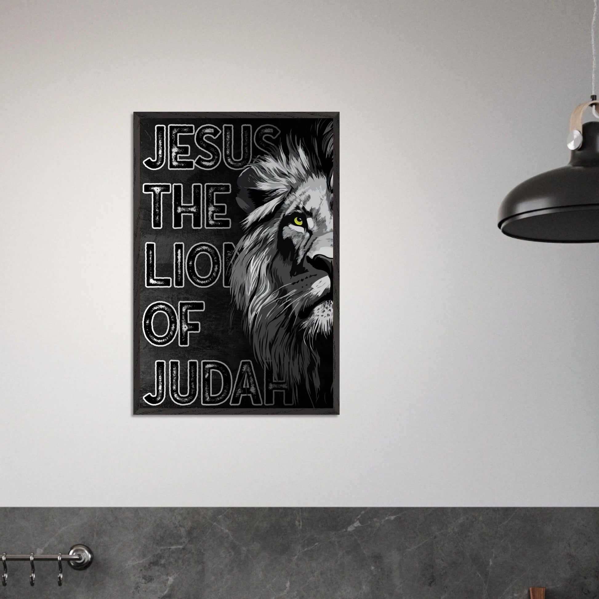Framed poster with a lion's head and 'Jesus, The Lion of Judah' text on a gray wall.
