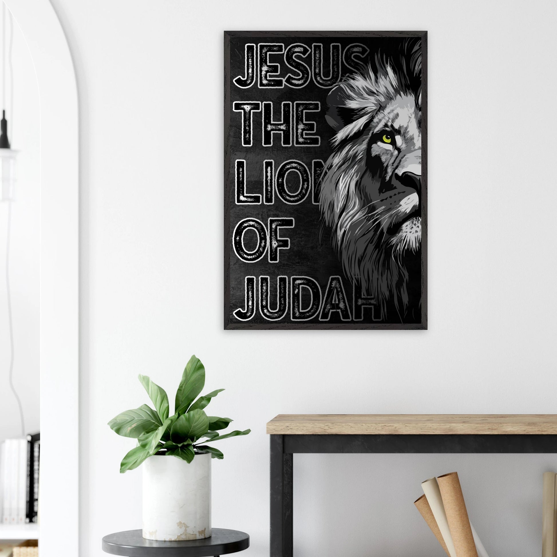 Poster with lion and text 'Jesus the Lion of Judah' on a white wall above a desk.
