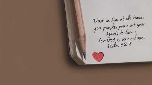 Notebook with a quote and heart symbol on a brown background