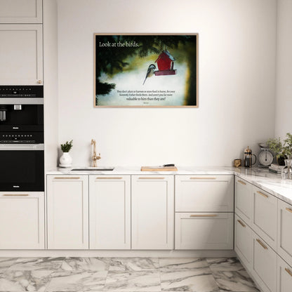 Modern kitchen with a framed picture of a red birdhouse on the wall.