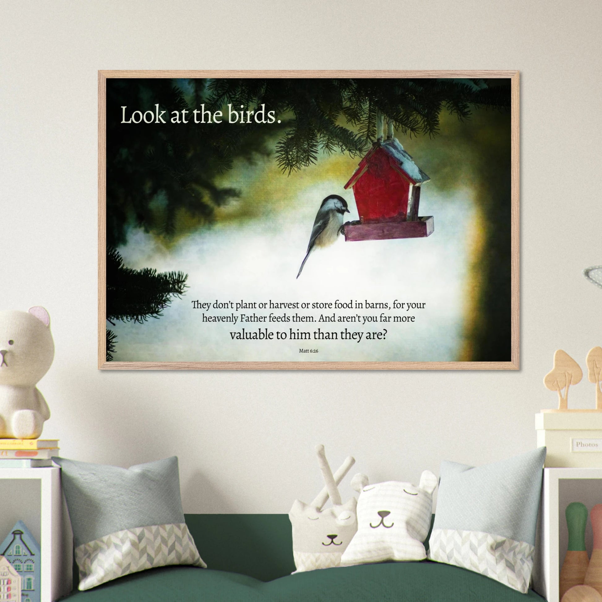 Framed artwork with a bird and birdhouse on a wall in a room with decorative items.