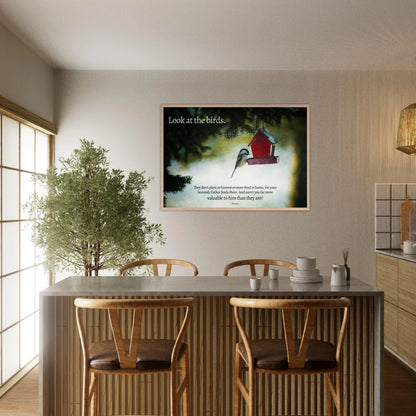 Dining room with a framed picture of birds and a red birdhouse on the wall.