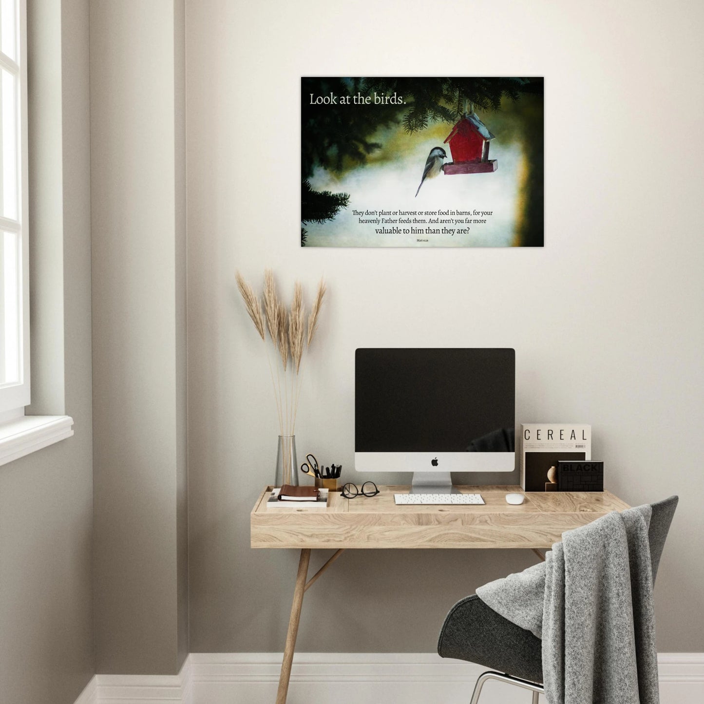 Modern home office with a desk, computer, and wall art featuring a birdhouse.