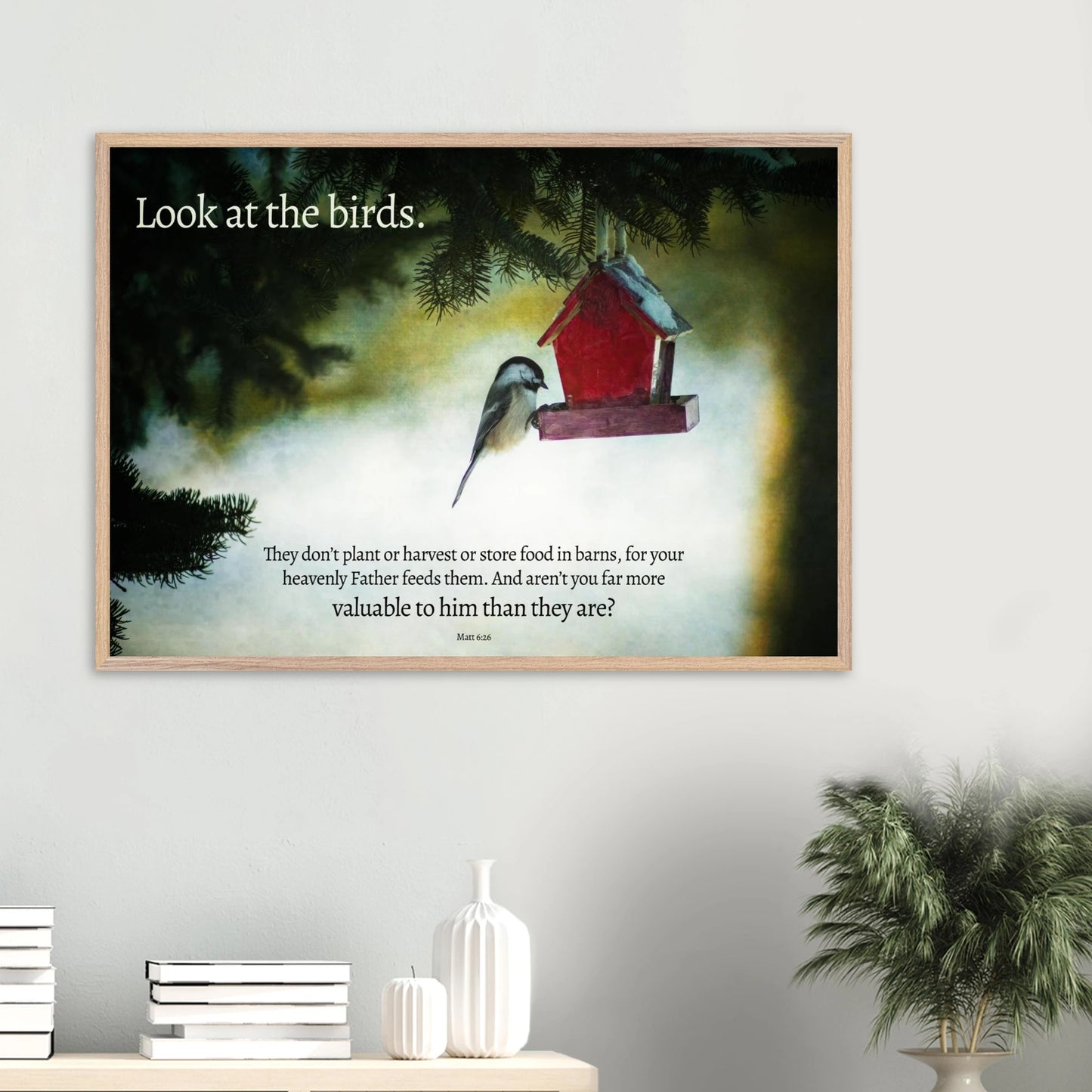 Framed artwork with a bird and birdhouse on a wall, featuring a quote.