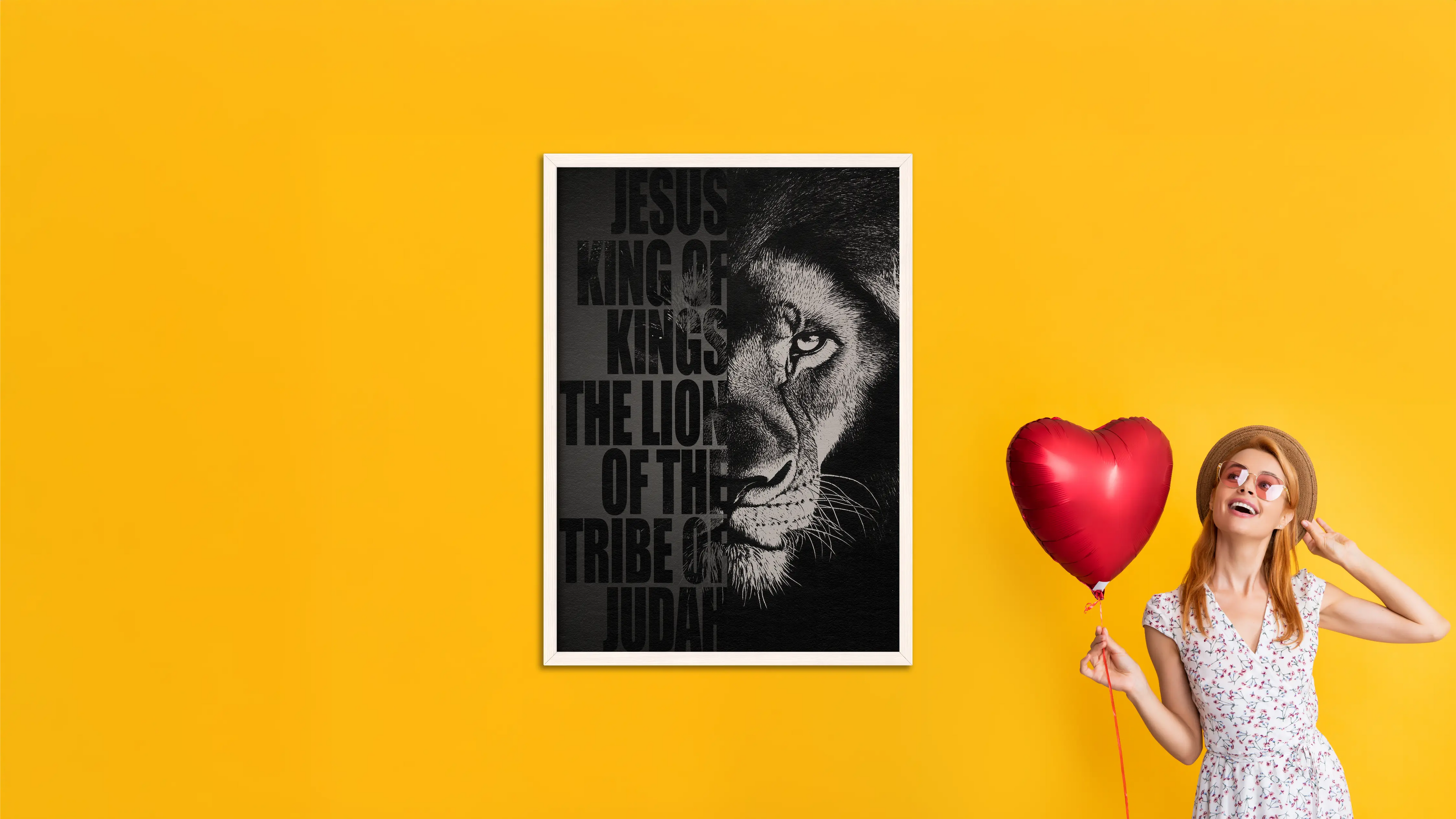 Woman holding a red heart balloon next to a framed picture of a lion with text on a yellow background