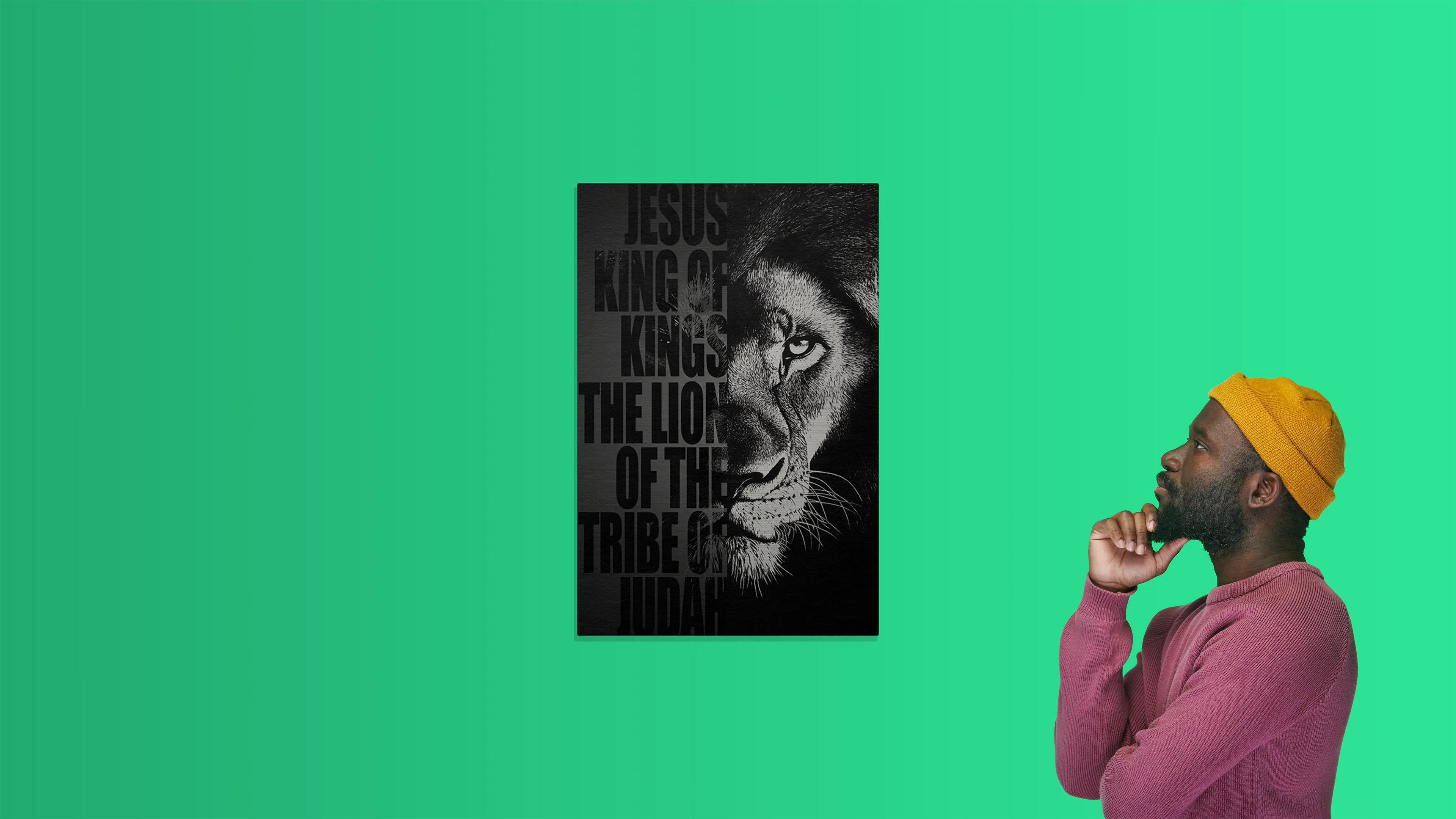 Man in a yellow beanie, with a poster of a lion representing Jesus the lion of Judah