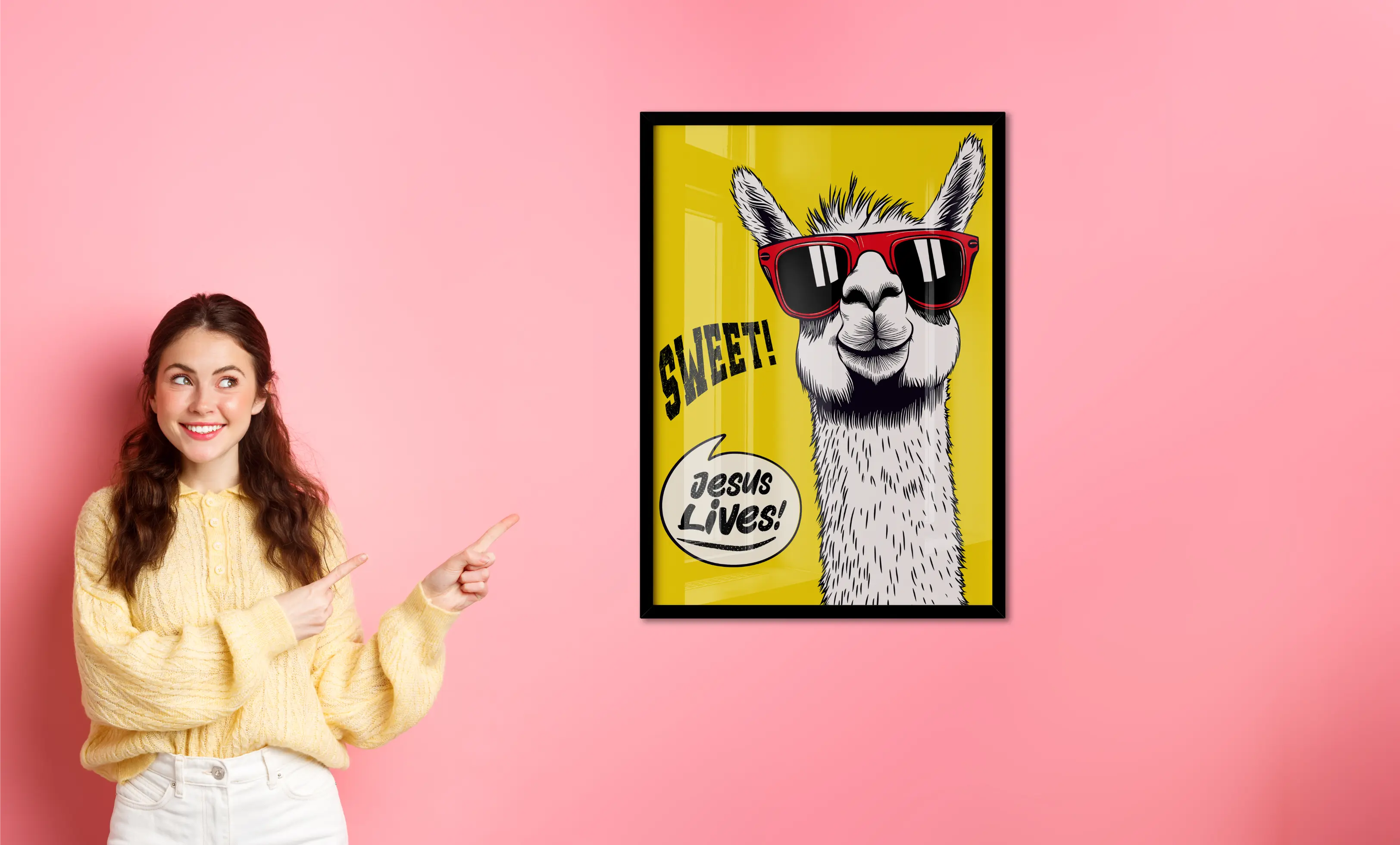 Woman pointing at a framed picture of a llama with sunglasses on a pink background