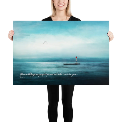 Person holding a large poster of a lighthouse over water with a quote.