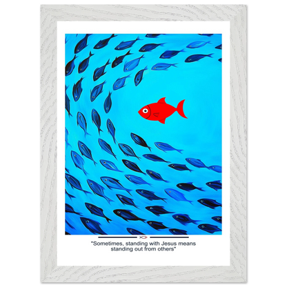 Framed Christian wall art featuring a red fish swimming in water with blue fish, and the text 'Sometimes standing with Jesus means standing out from others' as a quote.