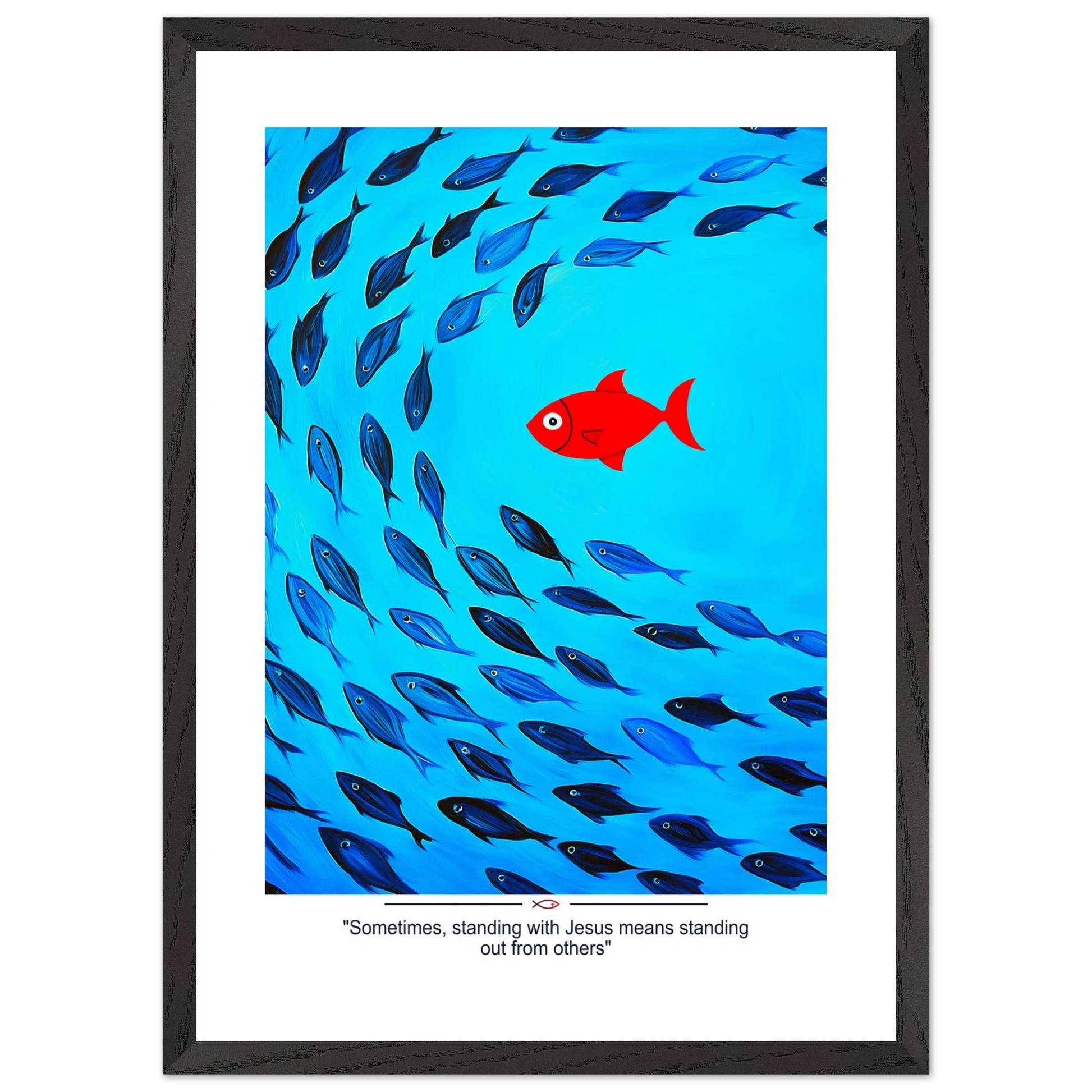 Framed Christian wall art featuring a red fish swimming in water with blue fish, and the text 'Sometimes standing with Jesus means standing out from others' as a quote.