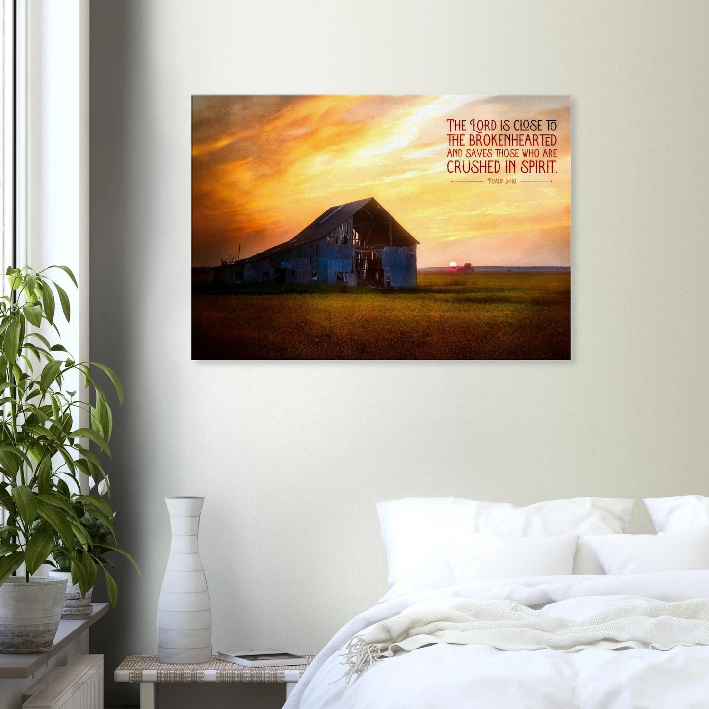 Framed artwork of a sunset over a barn with a motivational quote on a wall above a bed.