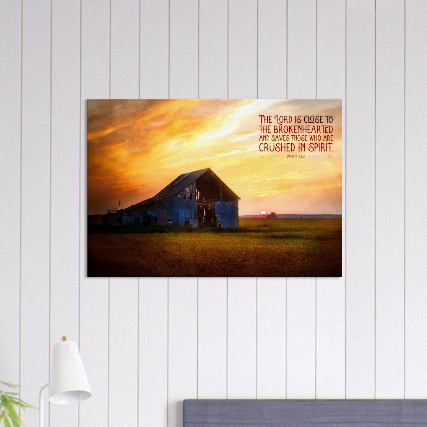 Framed artwork of a sunset over a barn with a motivational quote on a white wall.