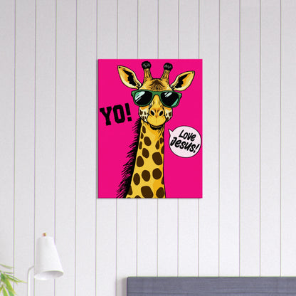 A vibrant pink poster featuring a cartoon giraffe with sunglasses and a speech bubble with the phrase 'Love Jesus!' The giraffe is the central figure against a vivid pink background displayed in a bright minimalist room with small lamp decor