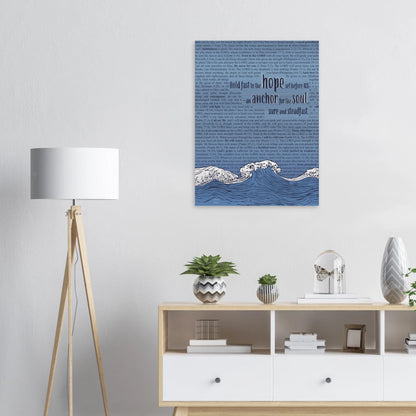 christian metal print featuring waves, an anchor, and scripture text in pink and silver displayed in a bright minimalist living space
