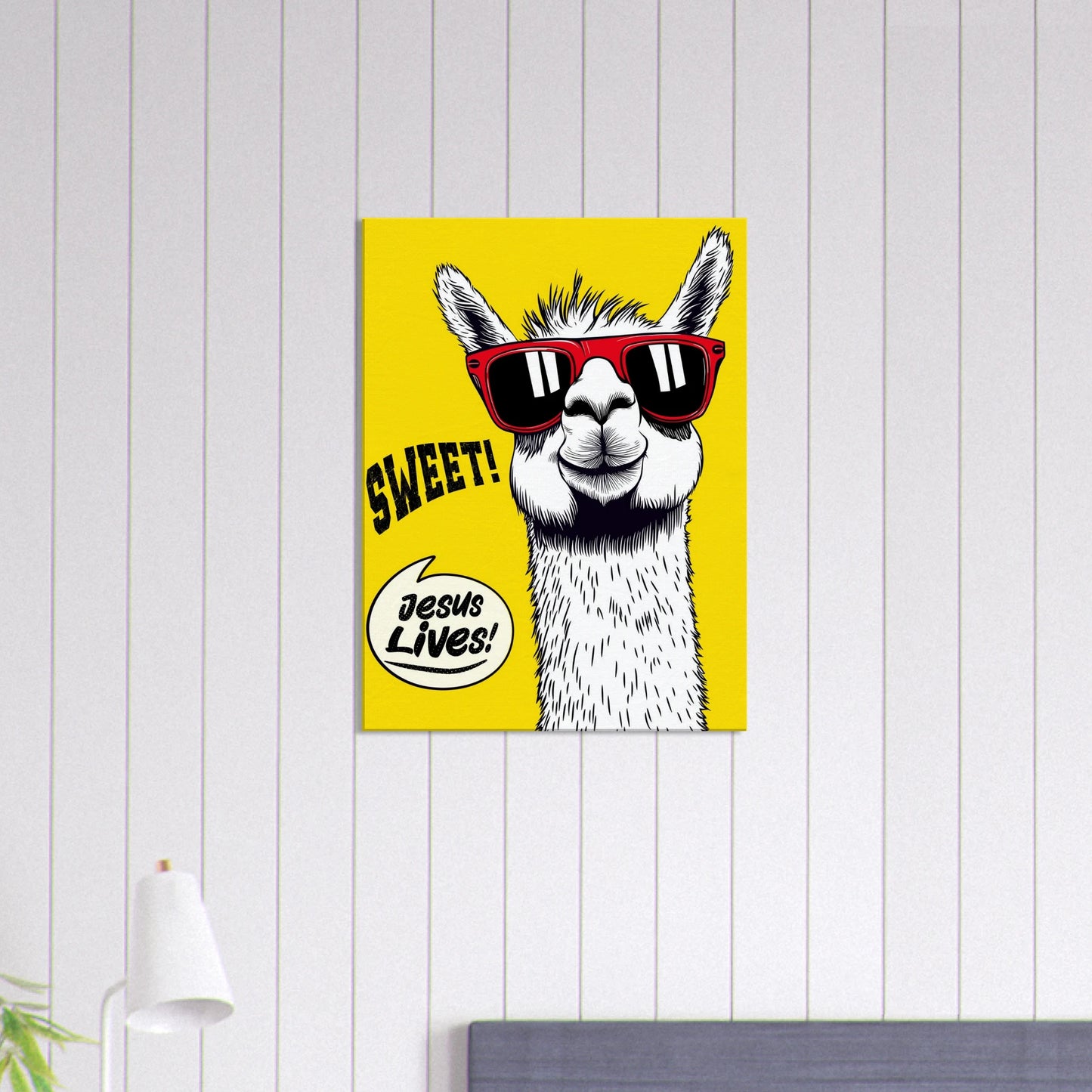sweet jesus lives christian poster with cool llama wearing red sunglasses on bright yellow background displayed on white shiplap wall