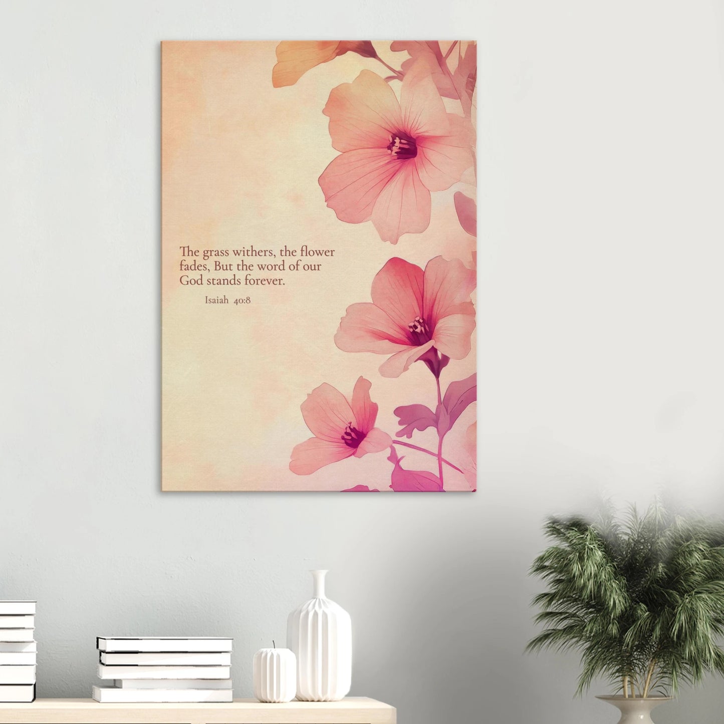 wall art print featuring floral design with pink flowers and the text of Isaiah 40:8 scripture, titled 'The Word of God Stands Forever' displayed in a modern minimalist room with plant and books decor
