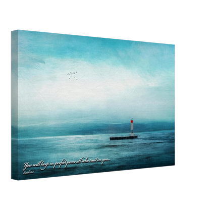 A canvas wall art print featuring a lighthouse with a backdrop of the sea and sky, including a quote about perfect peace.