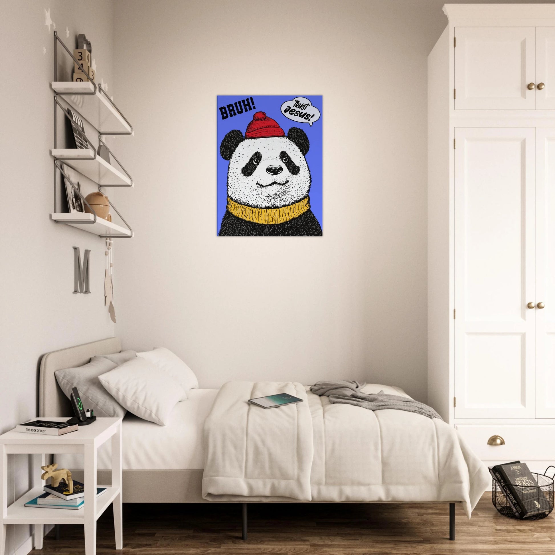 A canvas wall art featuring a cartoon illustration of a panda with a red beanie hat, a yellow scarf, and a speech bubble saying 'Trust Jesus' with a blue background displayed in a bright minimalist bedroom.