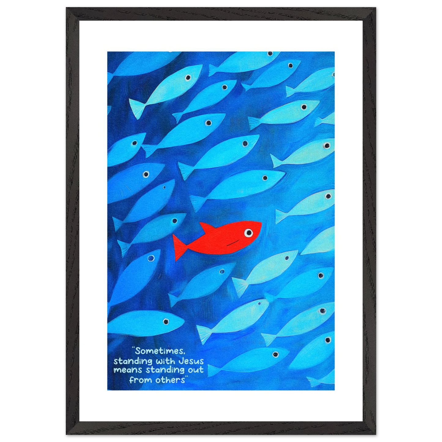 Framed wall art featuring a school of blue fish with a single red fish, and text that reads: 'Sometimes standing with Jesus means standing out from others.'.