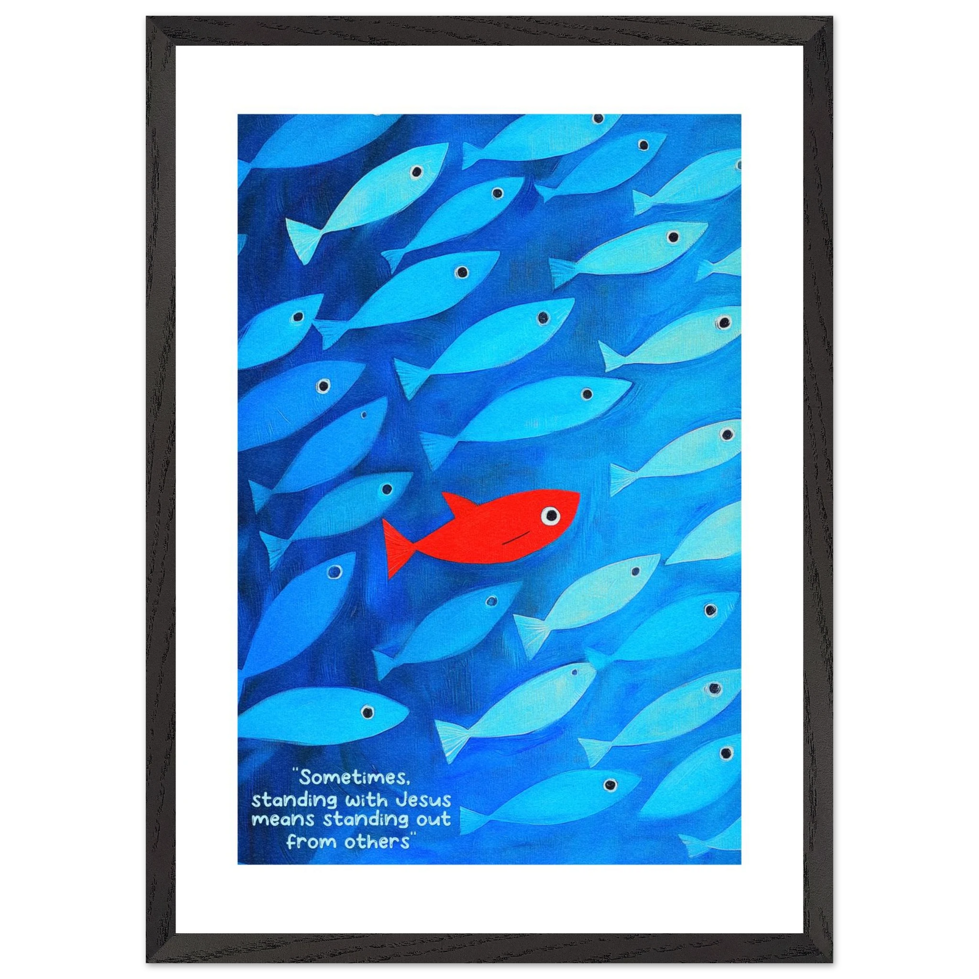 Framed wall art featuring a school of blue fish with a single red fish, and text that reads: 'Sometimes standing with Jesus means standing out from others.'.