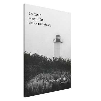 A canvas wall art print featuring a lighthouse with a black and white coastal landscape and the text of Psalm 27:1 which reads 'The Lord is my light and my salvation.'.