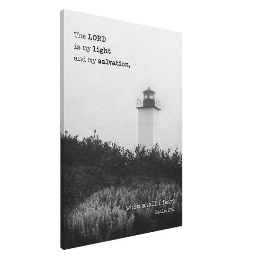A canvas wall art print featuring a lighthouse with a black and white coastal landscape and the text of Psalm 27:1 which reads 'The Lord is my light and my salvation.'.