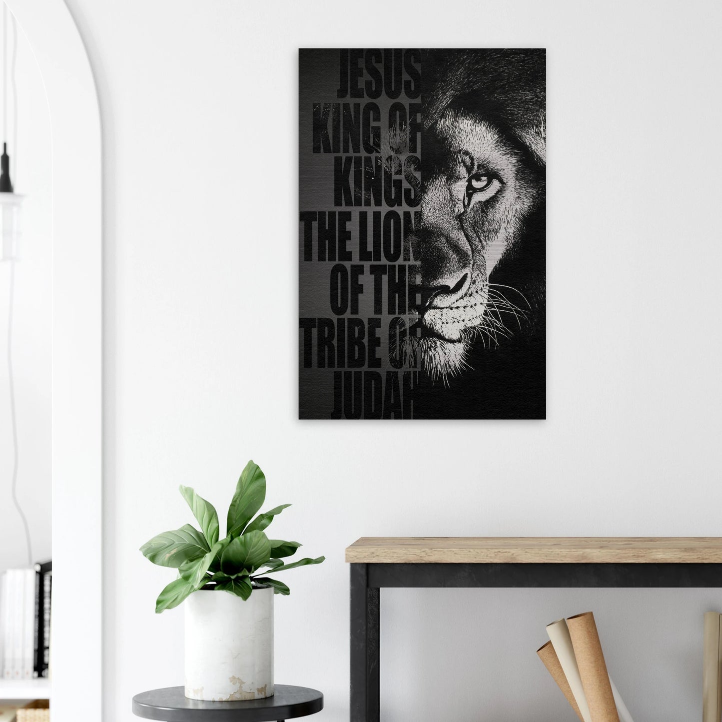 Black and white Lion of Judah Christian wall art featuring a powerful lion portrait with the words Jesus King of Kings Lion of the Tribe of Judah displayed in a modern minimalist interior and plant decor