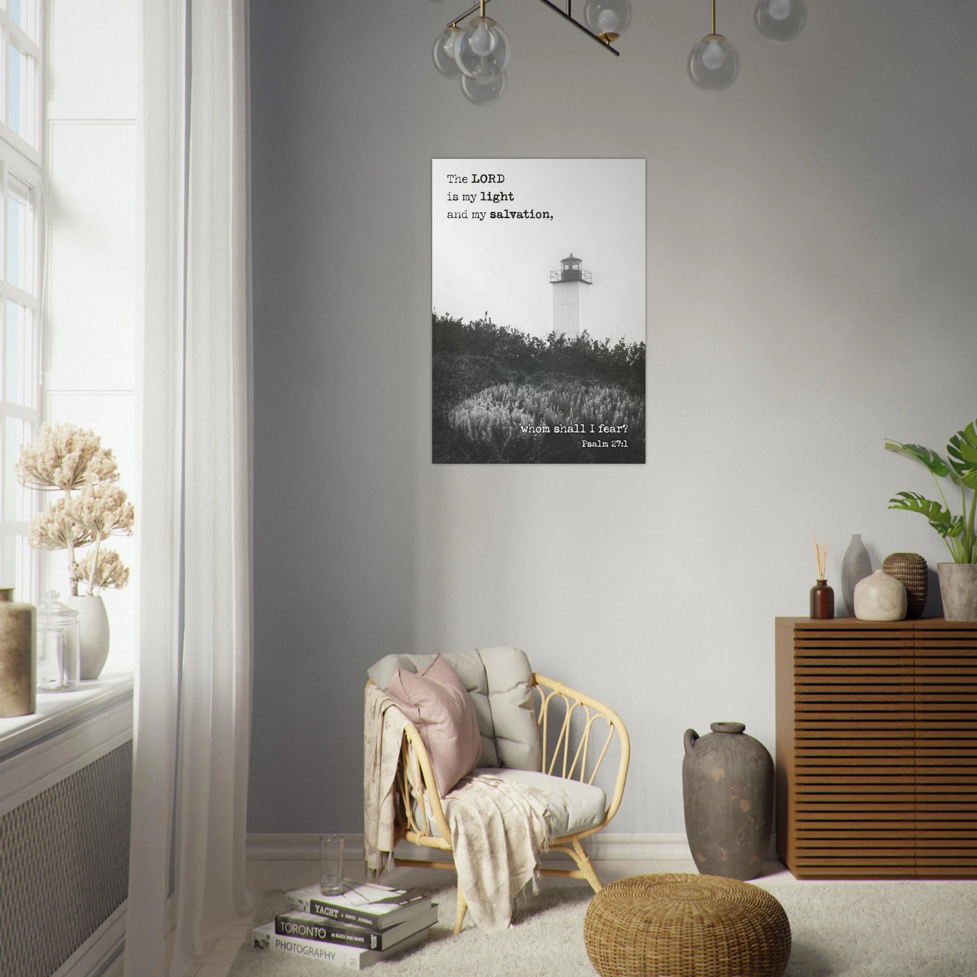 Living room with a chair, ottoman, and decor items against a gray wall with a framed picture.