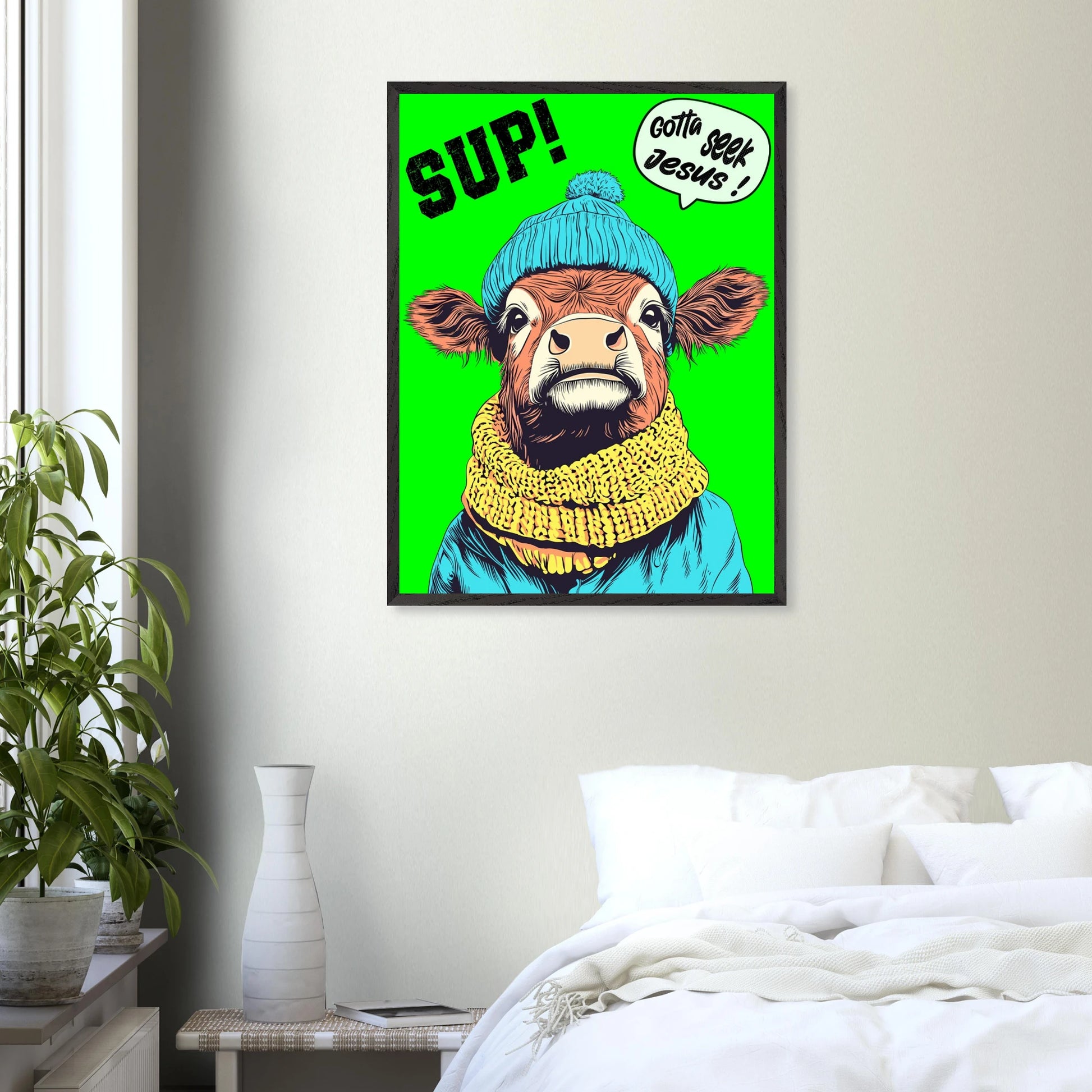 Playful Christian wall art featuring an illustrated cow wearing a blue beanie and yellow scarf on a bright green background, with SUP! and Gotta seek Jesus in a speech bubble, framed and styled in a modern bedroom interior