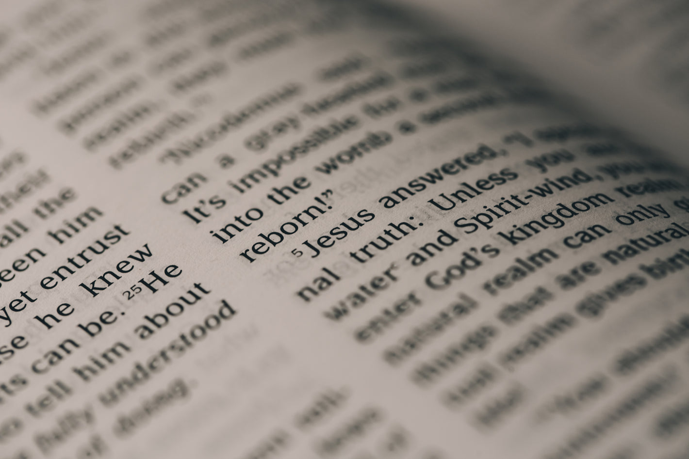 A close-up view of an open Bible with the words of Jesus in focus.