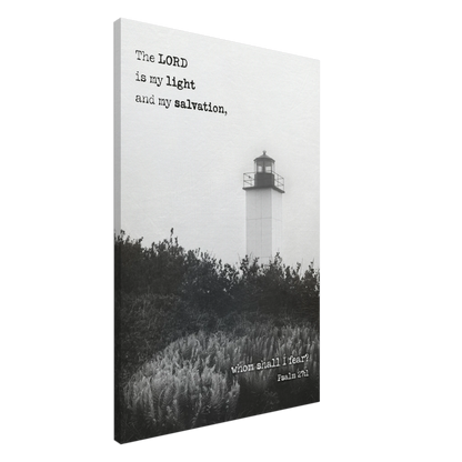 A canvas wall art print featuring a lighthouse with a black and white coastal landscape and the text of Psalm 27:1 which reads 'The Lord is my light and my salvation.'.
