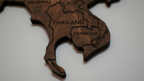 Wooden map of Southeast Asia with country names engraved on a white background