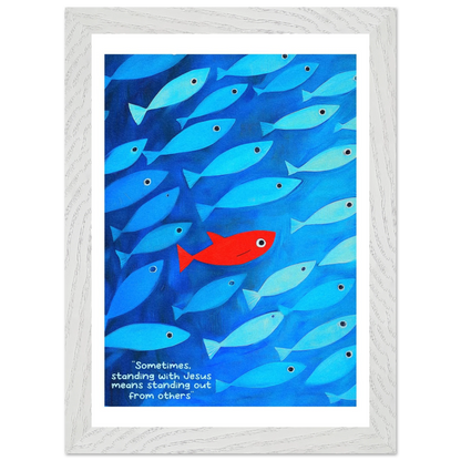 Framed wall art featuring a school of blue fish with a single red fish, and text that reads: 'Sometimes standing with Jesus means standing out from others.'.