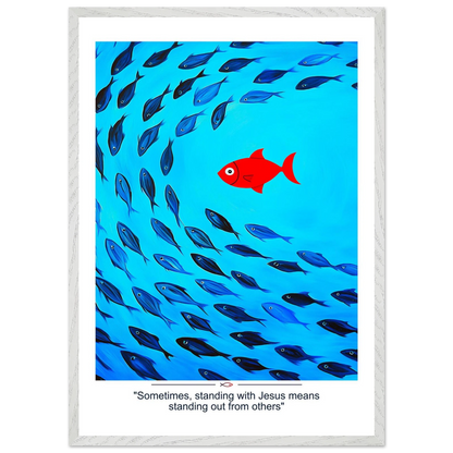 Framed Christian wall art featuring a red fish swimming in water with blue fish, and the text 'Sometimes standing with Jesus means standing out from others' as a quote.