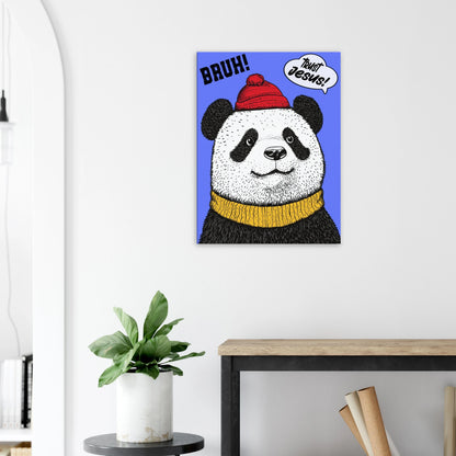 A canvas wall art featuring a cartoon illustration of a panda with a red beanie hat, a yellow scarf, and a speech bubble saying 'Trust Jesus' with a blue background displayed in a bright minimalist room with a small plant decor.