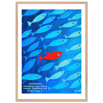 Framed wall art featuring a school of blue fish with a single red fish, and text that reads: 'Sometimes standing with Jesus means standing out from others.'.