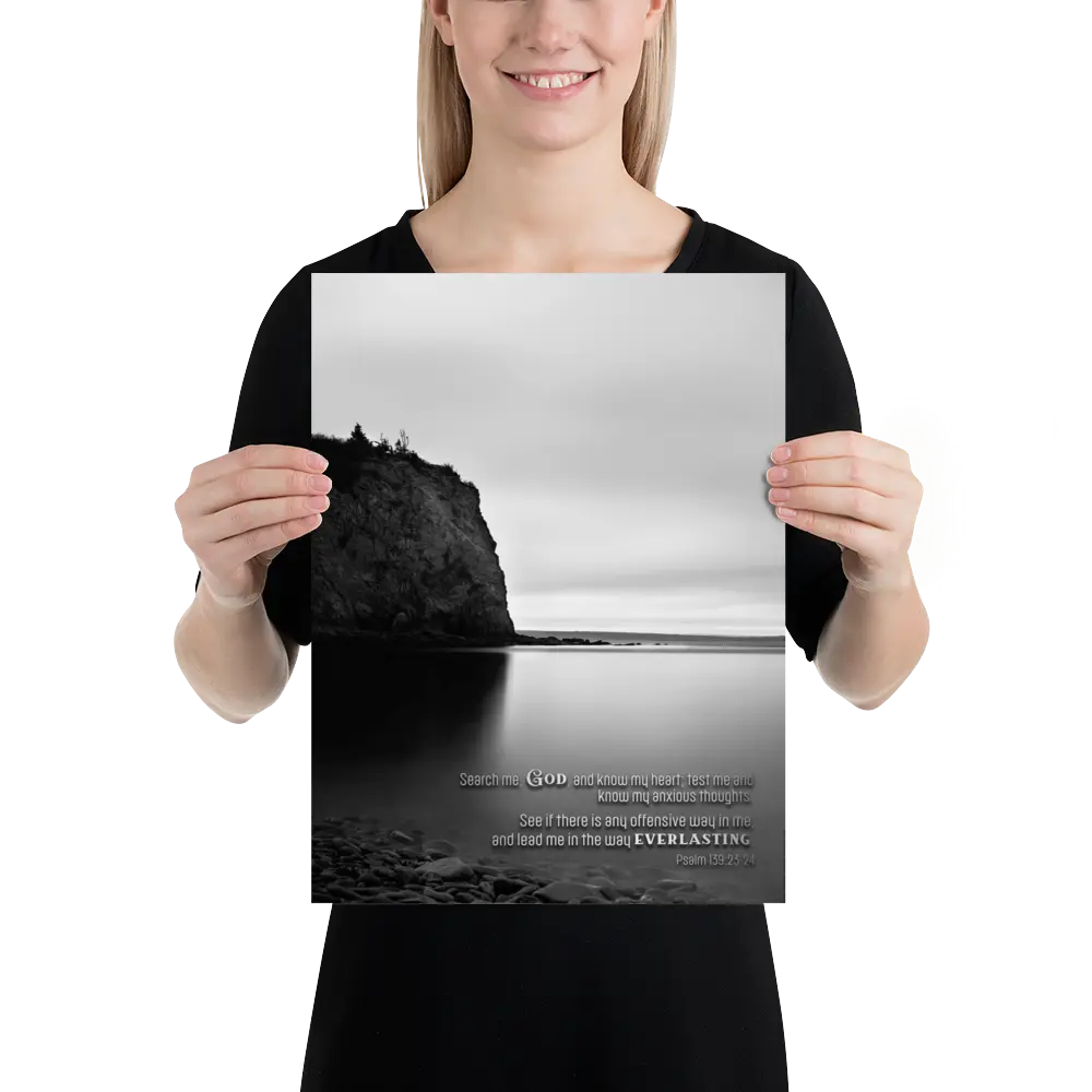 Person holding a poster with a scenic design and text.