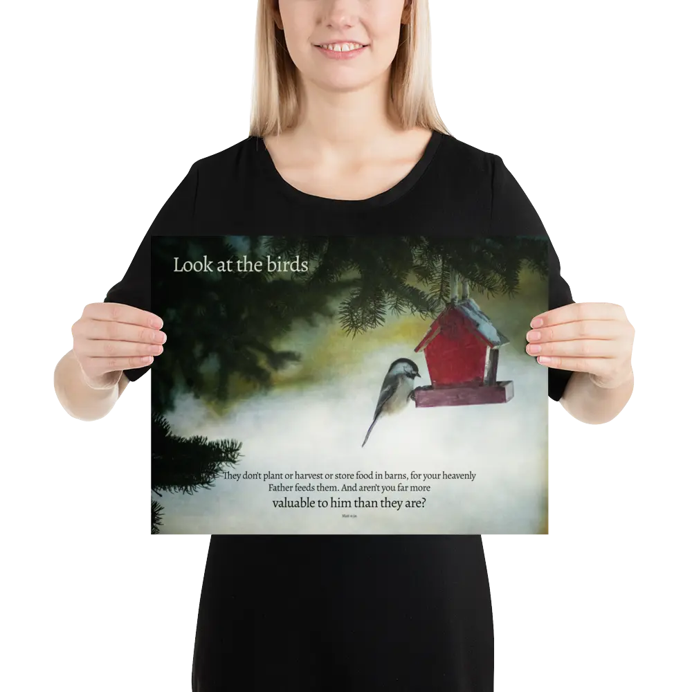 Person holding a poster with a bird and birdhouse illustration and text.
