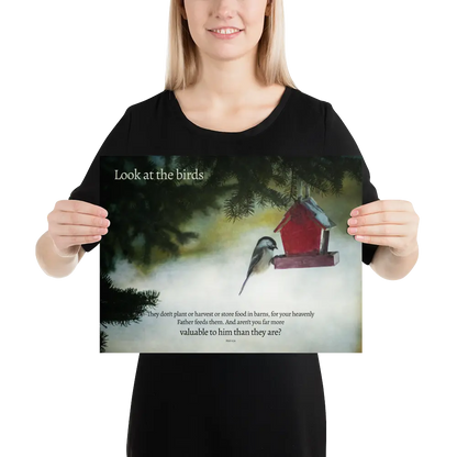Person holding a poster with a bird and birdhouse illustration and text.